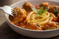 Close up meatballs with long Spaghetti in tomato sauce in a white plate on wooden table Royalty Free Stock Photo