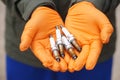 Close up mechanic hands hold old spark plug, spare part of car engine. Royalty Free Stock Photo