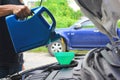 Close up of Mechanic pouring fresh oil to car engine Royalty Free Stock Photo