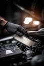 Close-up: Mechanic's Gloved Hand Installing a New Air Filter in a Car Engine Royalty Free Stock Photo