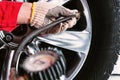 Close up of mechanic`s hand in glove checking the air pressure o Royalty Free Stock Photo