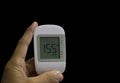 Close up medical device,digital handheld blood sugar detector isolated on black background. Royalty Free Stock Photo