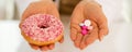 Closeup on medical doctor woman showing donut and pills Royalty Free Stock Photo