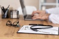 Close up of medical practitioner using laptop, side view