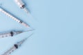 Close-up of medical syringe on blue background