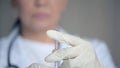 Close up of a medical syringe in hands of a professional doctor