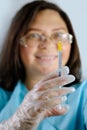 Close-up of medical syringe for injection into female hand, a doctor, a nurse preparing to inject vaccine, concept of compulsory Royalty Free Stock Photo