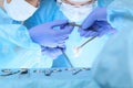Close up of medical team performing operation. Group of surgeons at work in operating theater Royalty Free Stock Photo