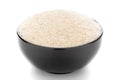 Close-up of medicinal organic isabgol husk or psyllium husks Plantago ovata in a black ceramic bowl over white background