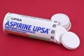 Open aspirin pill tube close up on red background Royalty Free Stock Photo