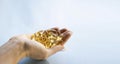 Close-up medicine yellow transparent pills, omega 3 fish oil capsules, vitamin D. Many yellow transparent capsules in