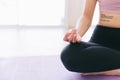 Close up of meditation hand of sporty Asian woman practicing yoga on yoga mat, doing Ardha Padmasana exercise. Royalty Free Stock Photo