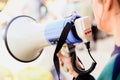 Close-up of a megaphone held by a woman during a demonstration