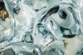 Close-up of melted glass texture, abstract, warped colors forming fluid, translucent shapes.
