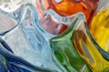 Close-up of melted glass texture, abstract, warped colors forming fluid, translucent shapes.