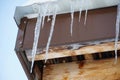 Close up melting icicles hanging from a roof at thaw weather Royalty Free Stock Photo