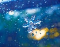 Close up of melting snowflake on the window with drops of water