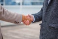 Business men in a coat on the pier shake hands. Royalty Free Stock Photo