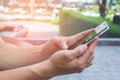 Close up of men hands holding touching mobile phone with blank copy space for your text message at park with light Sunset Royalty Free Stock Photo