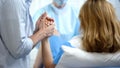 Close-up of man holding wife hand for support during pushing to give childbirth Royalty Free Stock Photo