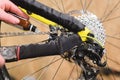 Close-up of men`s hands led by masters grease with special grease bicycle chain of mountain bike in the home workshop Royalty Free Stock Photo