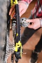 Close-up of men`s hands led by masters grease with special grease bicycle chain of mountain bike in the home workshop Royalty Free Stock Photo