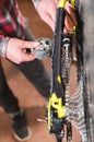 Close-up of men`s hands led by masters grease with special grease bicycle chain of mountain bike in the home workshop Royalty Free Stock Photo