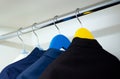 Close-up of men`s suits on a hanger. Elegant suits are stored in a closet. Royalty Free Stock Photo