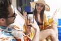 Close up of man taking a photo of a woman