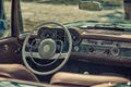 Close up on Mercedes vintage car steering wheel and cockpit