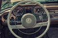 Close up on Mercedes vintage car steering wheel and kockpit