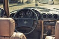 Close up on Mercedes vintage car steering wheel and kockpit
