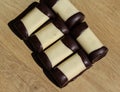 typical dutch sweet cookie called & x22;mergpijpje& x22; covered with white marzipan, on a wooden background Royalty Free Stock Photo