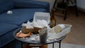 Close up of messy table, leftover food, dirty dishes in empty living room Royalty Free Stock Photo