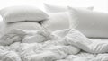 Close up of a messy white bed with crumpled duvet and pillows Royalty Free Stock Photo
