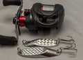 Fishing lures and bait casting reel on a plain background Royalty Free Stock Photo