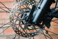 Close-up of a metal brake disc on the front wheel of a mountain bike. Outdoors Royalty Free Stock Photo