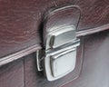 Metal buckle or clasp on an old scratched leather suitcase