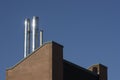 Close up metal chimneys on the factory roof. Royalty Free Stock Photo
