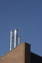 Close up metal chimneys on the factory roof. Royalty Free Stock Photo