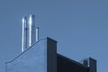 Close up metal chimneys on the factory roof. Royalty Free Stock Photo