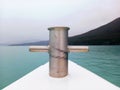 Close up of metal cleat on boat deck and jagged bottom of frozen lake. Mooring and anchoring. Nature and extreme landscapes of