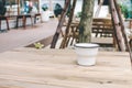 Close up of metal cup on old wooden table. Mockup of white enamel cup. Royalty Free Stock Photo