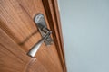 Close up of a metal door handle on wooden doors Royalty Free Stock Photo