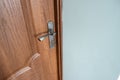 Close up of a metal door handle on wooden doors Royalty Free Stock Photo