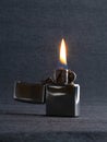 Close-up of metal gas lighter with burning fire on grey background Royalty Free Stock Photo