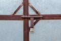 Close-up of a metal gate with a rusty crossbar lock Royalty Free Stock Photo