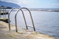 Close up of a metal ladder leading into a natural sea pond