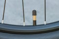 Close-up of a metal nipple of a bicycle wheel chamber with a protective cap screwed on. Outdoors Royalty Free Stock Photo