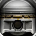Close-up of a metal piston head, likely from an internal combustion engine. The Royalty Free Stock Photo